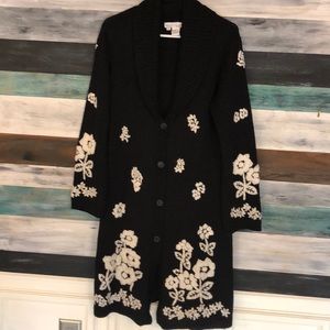 Knee length embroidered button up sweater.